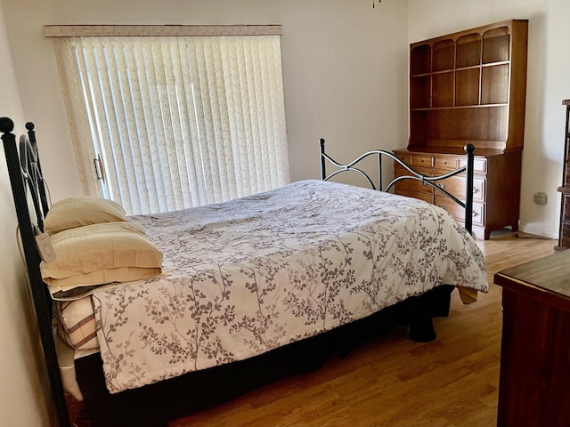 bedroom with wood finished floors