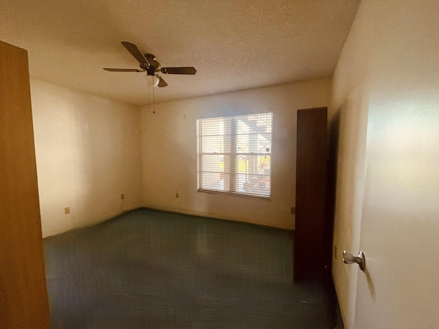 spare room featuring a textured ceiling and a ceiling fan