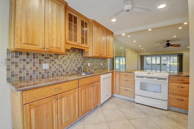 kitchen featuring light stone counters, a peninsula, white appliances, ornamental molding, and glass insert cabinets