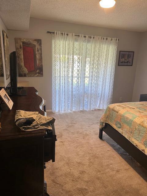 carpeted bedroom featuring a textured ceiling