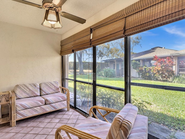 sunroom / solarium featuring ceiling fan