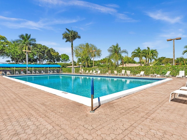 pool featuring a patio area and fence