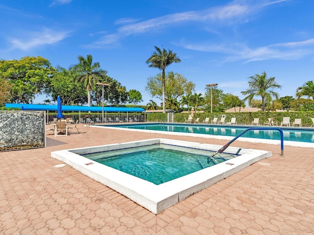 pool with fence and a patio