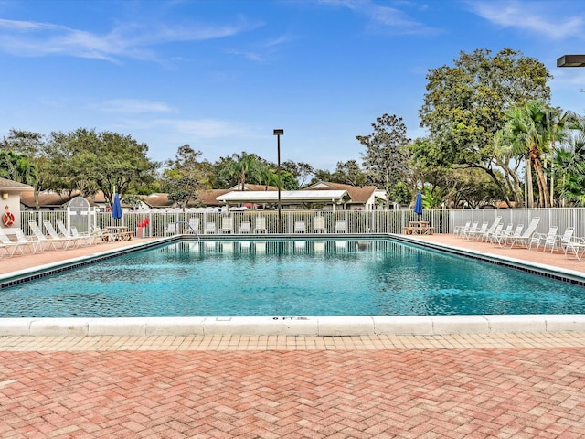 pool featuring a patio area and fence