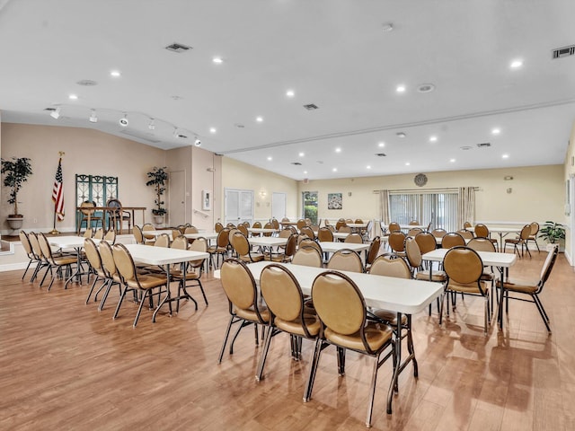 dining area featuring light wood-style floors, recessed lighting, visible vents, and vaulted ceiling