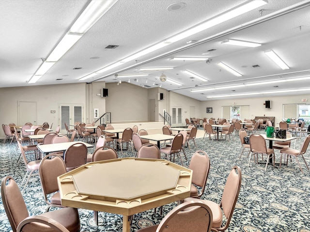 dining room featuring vaulted ceiling, a textured ceiling, carpet, and visible vents