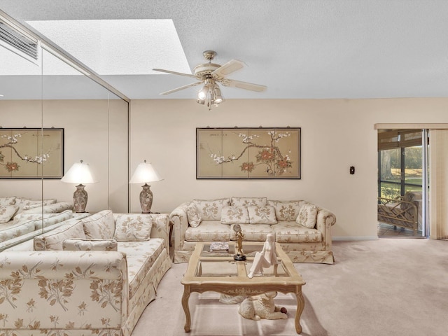 living area featuring a textured ceiling, carpet floors, and a ceiling fan