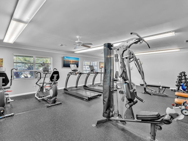 gym with crown molding, a ceiling fan, and baseboards