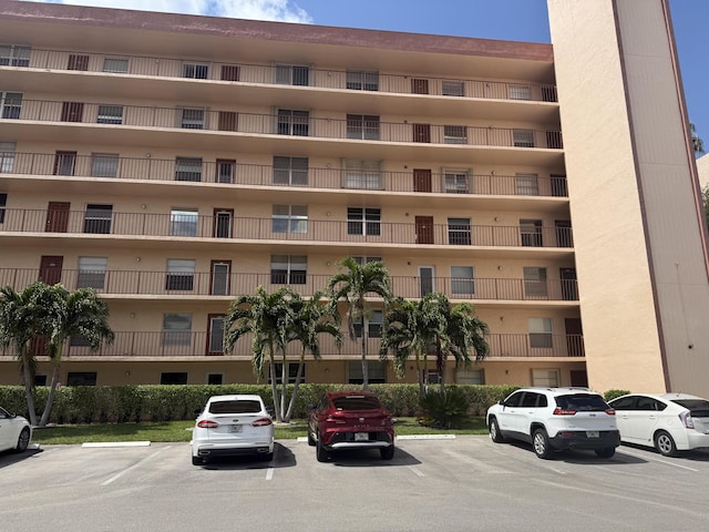 view of building exterior with uncovered parking