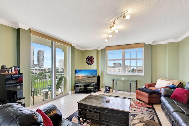 living area with crown molding, light tile patterned floors, rail lighting, a textured ceiling, and a wall of windows