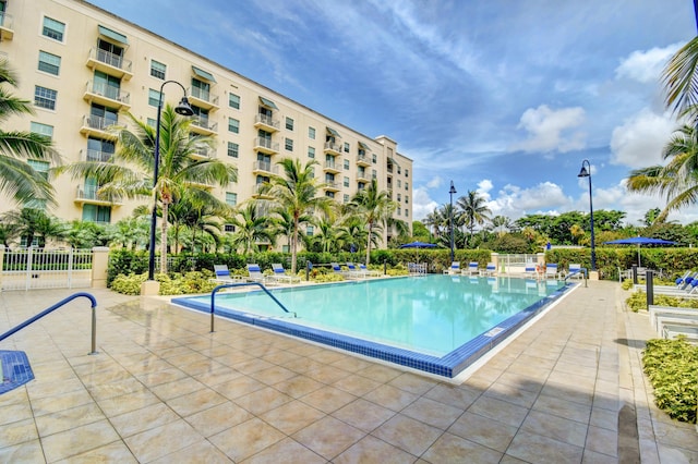 community pool featuring a patio area and fence