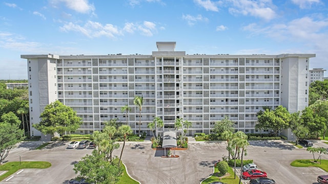 view of building exterior featuring uncovered parking