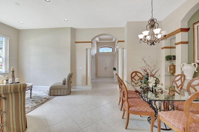 dining space with arched walkways, recessed lighting, light tile patterned flooring, and baseboards