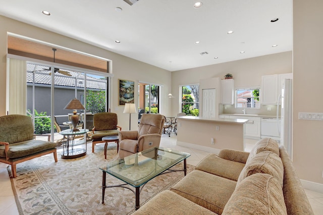 living room with light tile patterned floors, baseboards, and recessed lighting