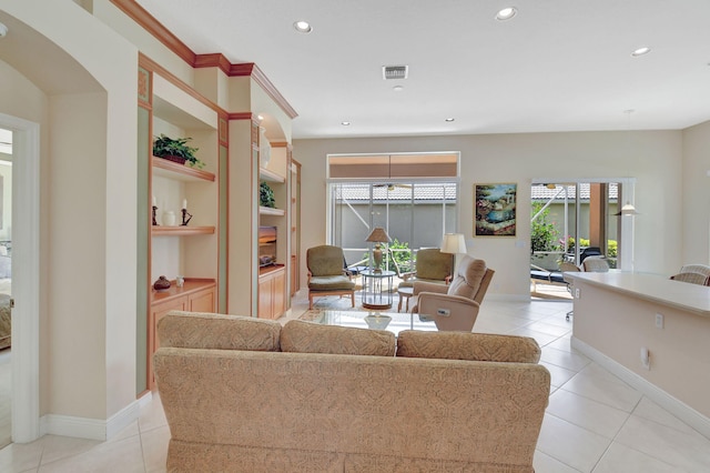 living area with built in features, visible vents, a wealth of natural light, and recessed lighting