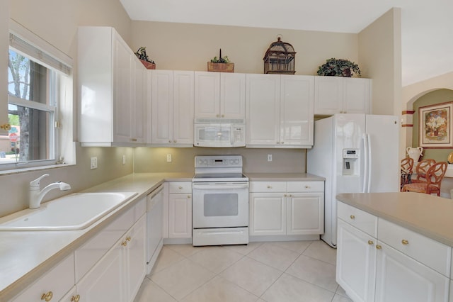 kitchen featuring light countertops, white appliances, a sink, and white cabinetry