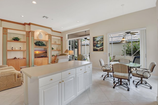 kitchen with decorative light fixtures, recessed lighting, light countertops, a ceiling fan, and white cabinets