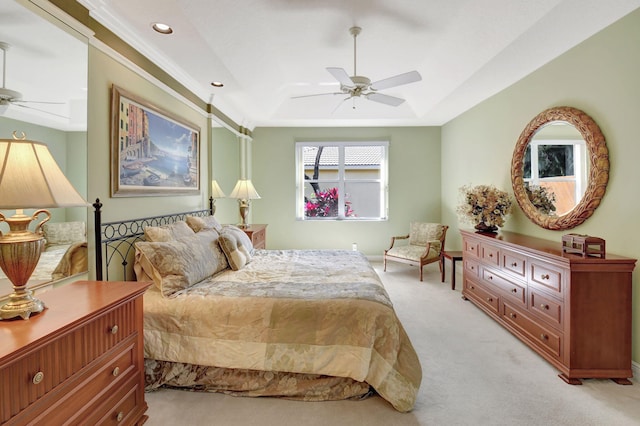 bedroom featuring light carpet, ceiling fan, a raised ceiling, and recessed lighting