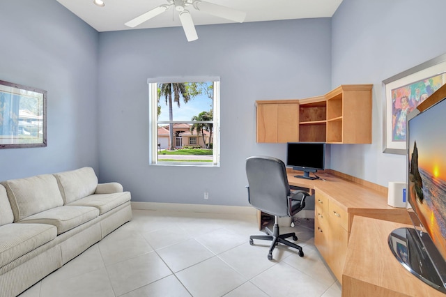 home office with light tile patterned flooring, ceiling fan, and baseboards