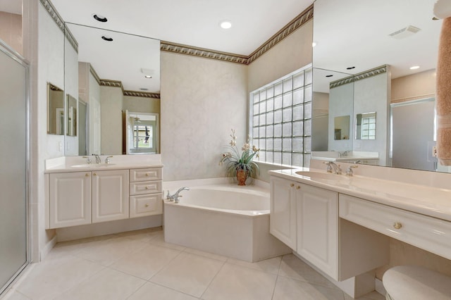 full bathroom featuring a stall shower, a sink, a bath, and tile patterned floors