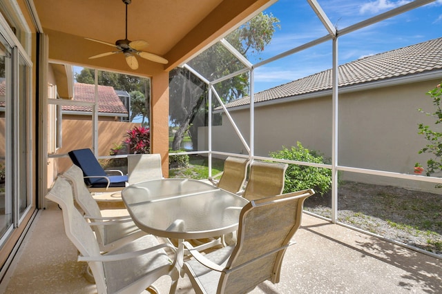 sunroom featuring ceiling fan