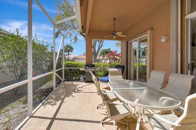 sunroom featuring ceiling fan