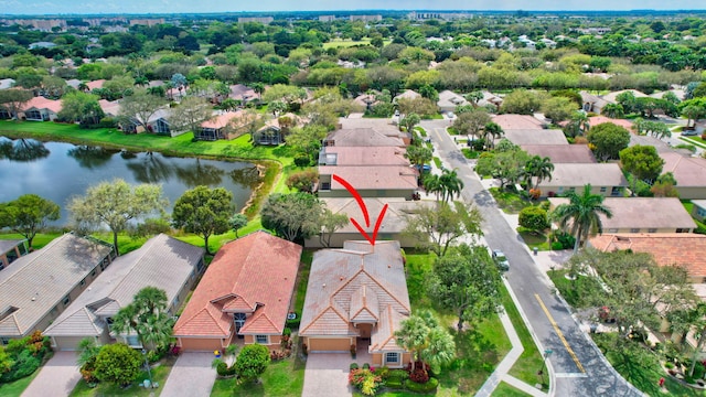 drone / aerial view with a residential view and a water view