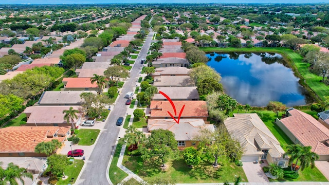 birds eye view of property featuring a water view and a residential view