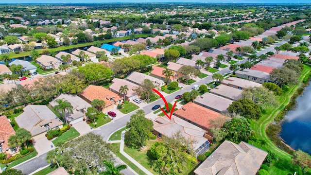 drone / aerial view with a water view and a residential view