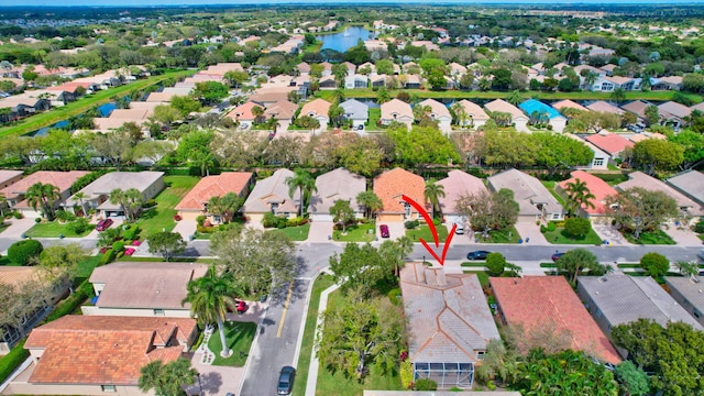 drone / aerial view featuring a water view and a residential view