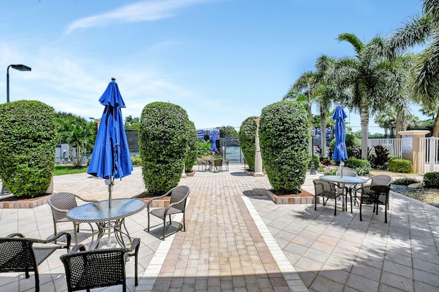 view of patio with outdoor dining space and fence