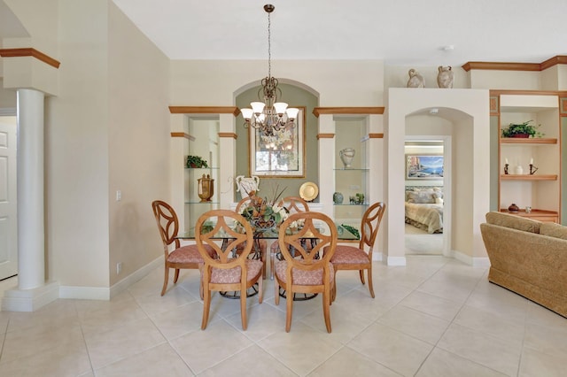 dining area featuring light tile patterned floors, baseboards, a chandelier, and built in features