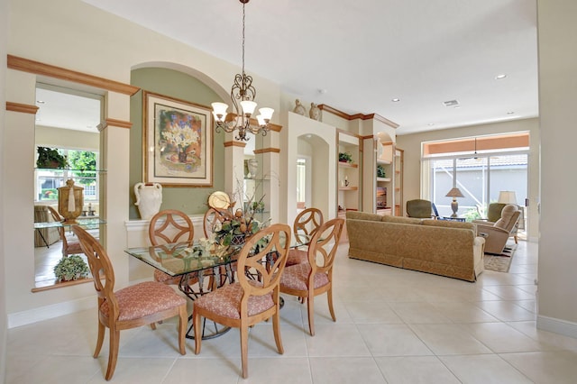 dining area with a chandelier, plenty of natural light, light tile patterned flooring, and recessed lighting