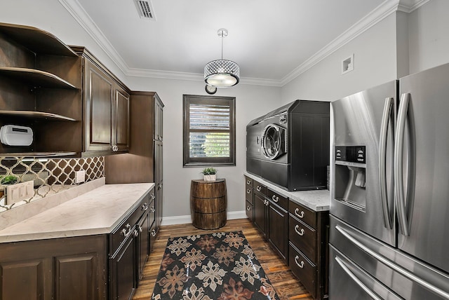 kitchen with dark brown cabinetry, stainless steel fridge, light countertops, and dark wood finished floors