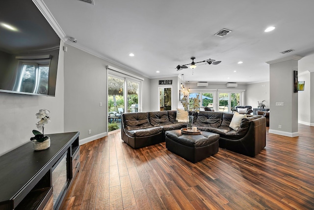 living room with wood finished floors, visible vents, and a healthy amount of sunlight