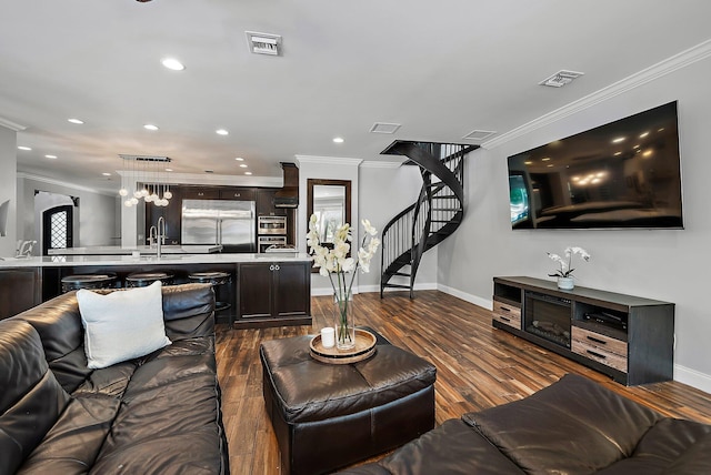 living area featuring stairway, visible vents, dark wood-type flooring, and crown molding