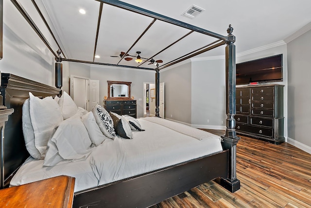 bedroom with crown molding, recessed lighting, visible vents, wood finished floors, and baseboards