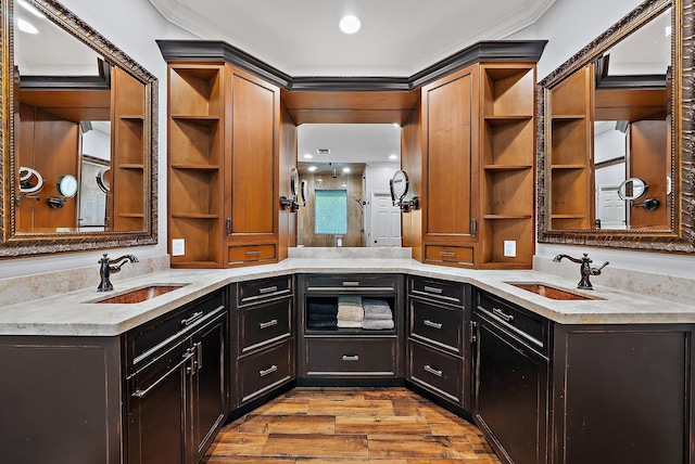 kitchen with open shelves, wood finished floors, and a sink