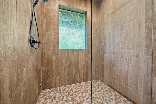 bathroom with a tile shower