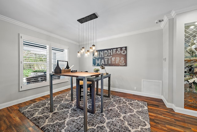 dining area featuring baseboards, visible vents, wood finished floors, and ornamental molding