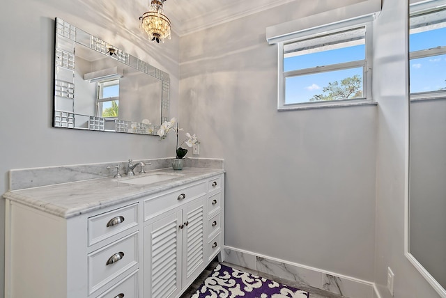 bathroom with marble finish floor, baseboards, ornamental molding, and vanity