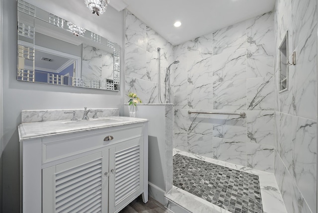 full bath featuring vanity and a marble finish shower