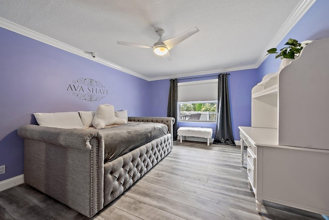 bedroom featuring light wood finished floors, baseboards, a ceiling fan, ornamental molding, and a textured ceiling