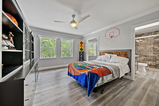 bedroom with crown molding, a textured ceiling, and wood finished floors