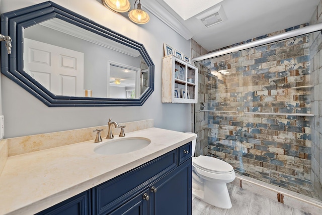 full bathroom featuring a stall shower, visible vents, toilet, wood finished floors, and vanity