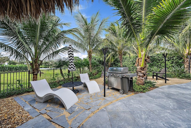 view of patio / terrace with grilling area and fence