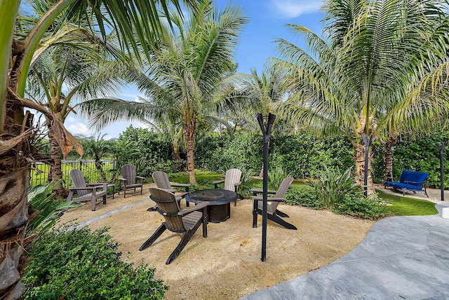 view of patio / terrace with an outdoor fire pit and fence