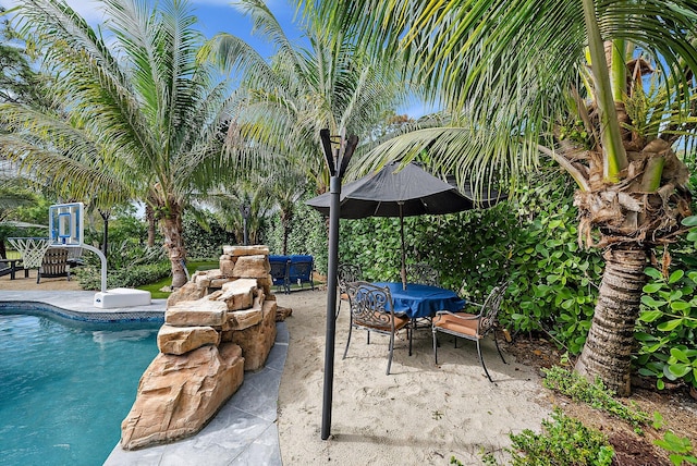 pool featuring outdoor dining space and a patio