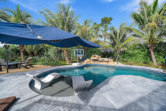 outdoor pool with an outdoor fire pit and a patio area