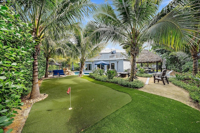 view of community featuring a patio, a gazebo, and a pool